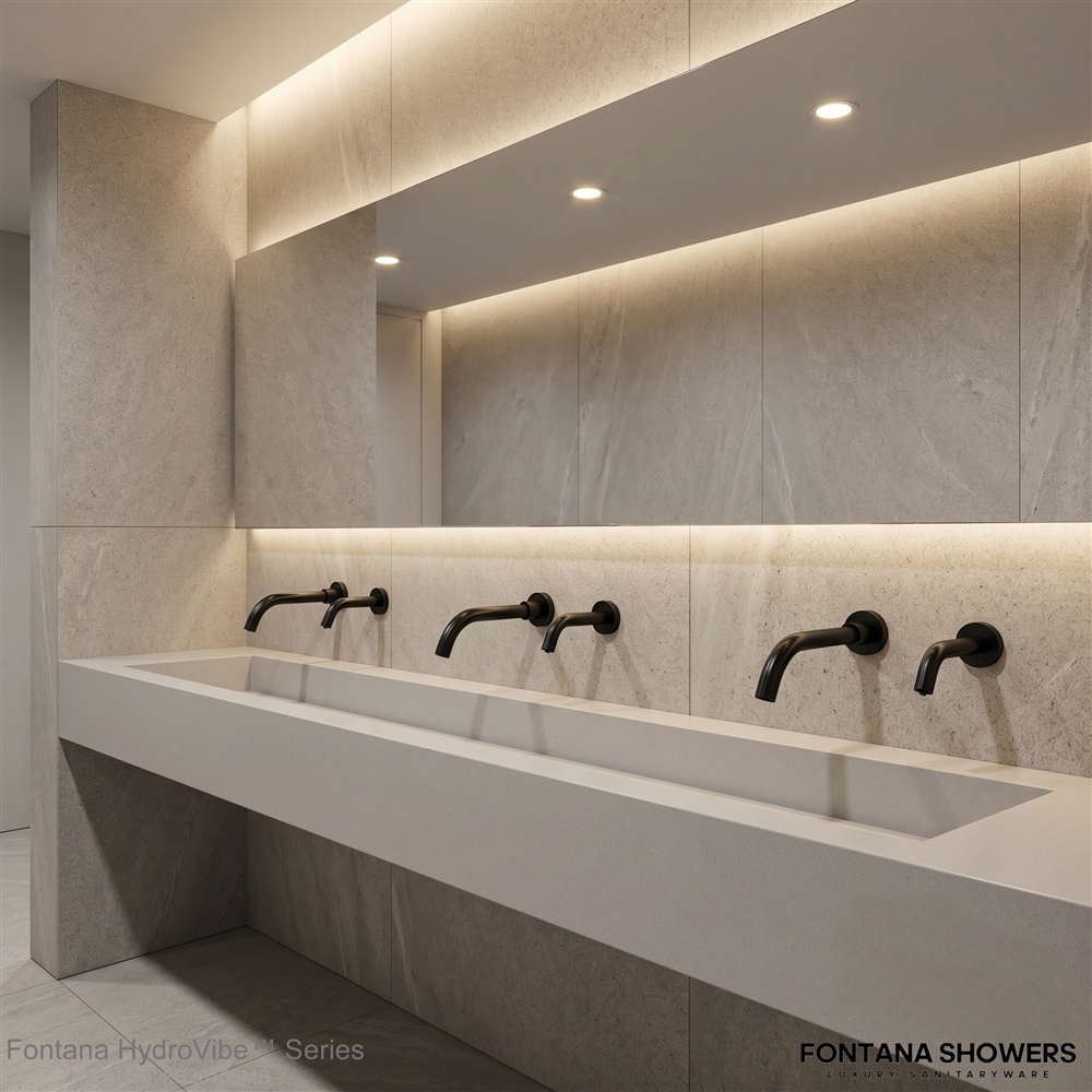 Matte black commercial touchless faucet for a modern office washroom design