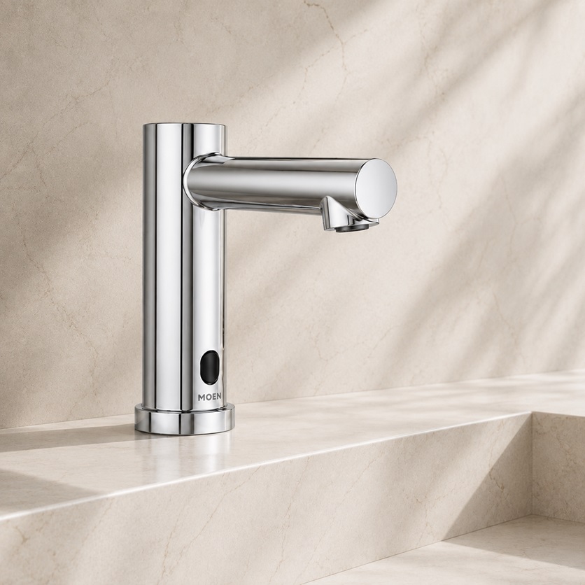Modern touchless faucet with sensor activation near a clean sink basin