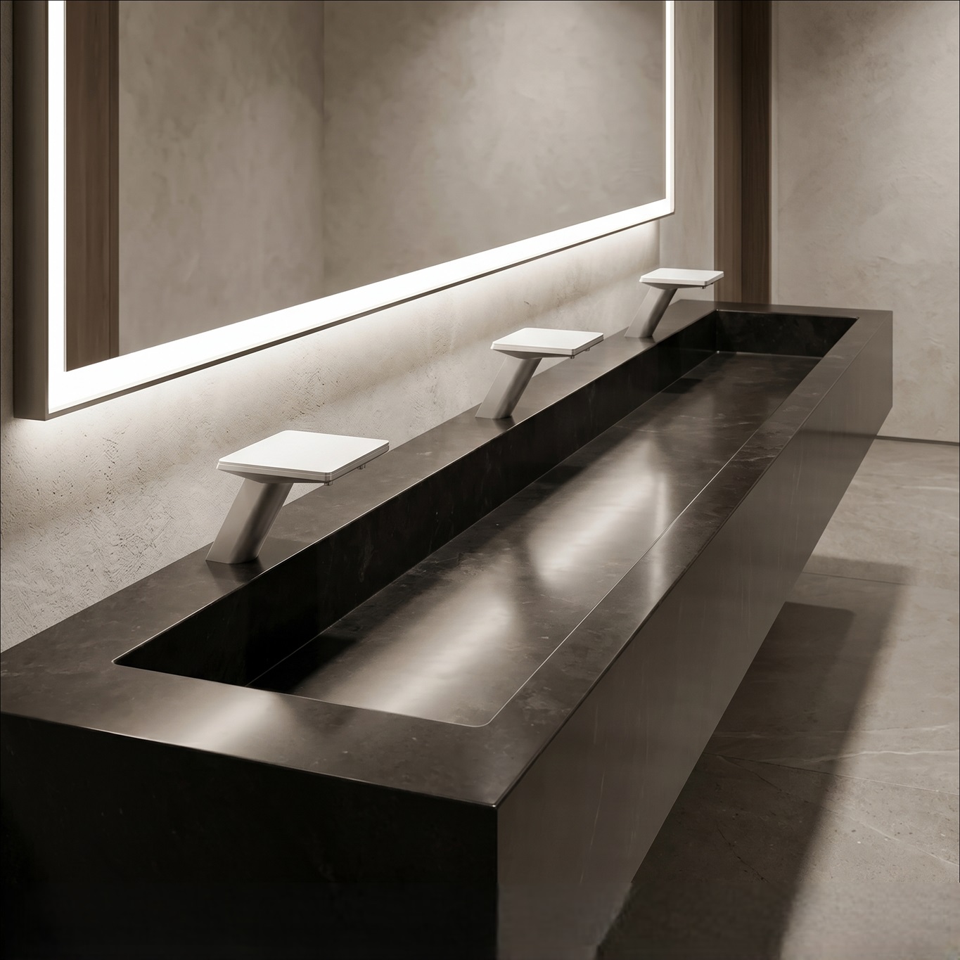 Wall-mounted gold touchless faucets arranged above individual sinks in a commercial washroom